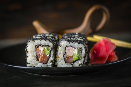 sushi rolls in black sesame on a dishの写真素材