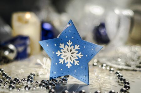 Christmas toy star snowflake on a white-blue backgroundの写真素材