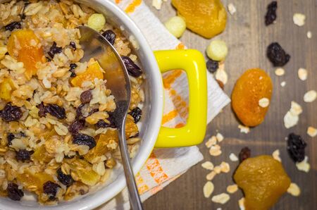 Diet food, oatmeal with dried fruits on a wooden tableの写真素材