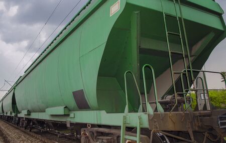 Green wagons as part of a freight train on rails