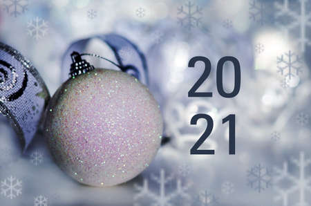 New year card with a Christmas tree toy and the inscription two thousand twenty one