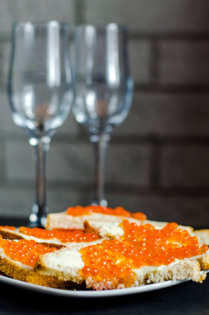sandwich with butter and red caviar on a plateの写真素材