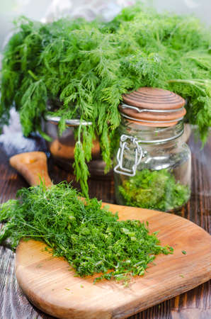 Green young dill sliced on a kitchen board. Freshly cut greensの写真素材