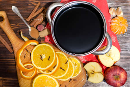 Ingredients for making mulled wine. Oranges, wine and spices for making a hot drinkの写真素材
