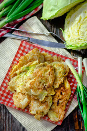 Cabbage fried in batter on a plate. Hot appetizer close-up.の写真素材