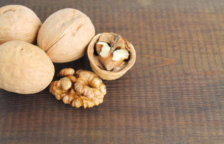 walnuts close-up on a dark brown wooden background.の写真素材