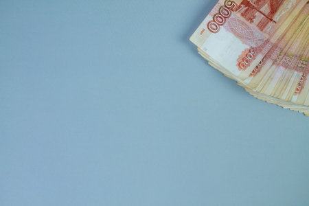 Big stack of Russian money banknotes of five thousand rubles lying on a grey background. Space for textの写真素材