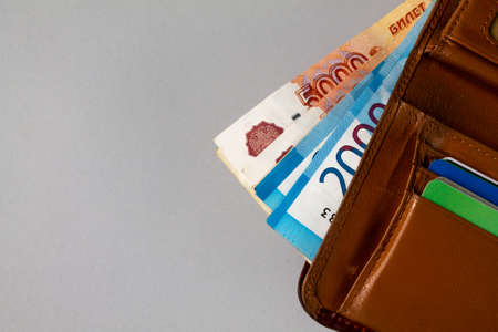 Wallet with Russian money lies on a gray background. Space for textの写真素材