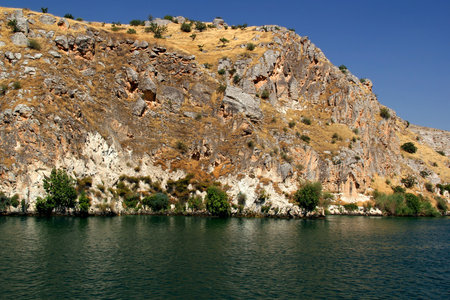 Landscape with mountains and smooth surface of Euphrates River in the town of Halfeti in Southeast Anatolia region of Turkeyの写真素材