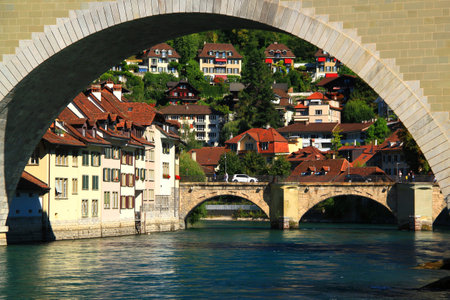 View of Are river, arched bridge Untertorbrucke and hillside houses in Bern, Switzerland