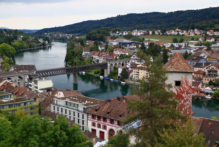 View of the river Rhine (Rhein), the iron arch bridge across it and the in Schaffhausen buildings,...