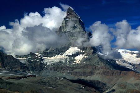 A landscape with a mountain Matterhorn view partially covered by clouds on a mountain Gornergrat, near Zermatt, in southern Switzerlandの写真素材