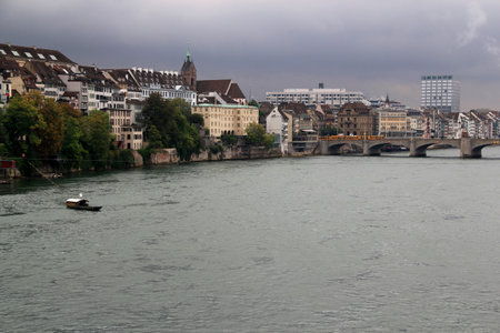View of the city of Basel (northern Switzerland) before a thunderstorm with the Rhine (Rhein) river,...