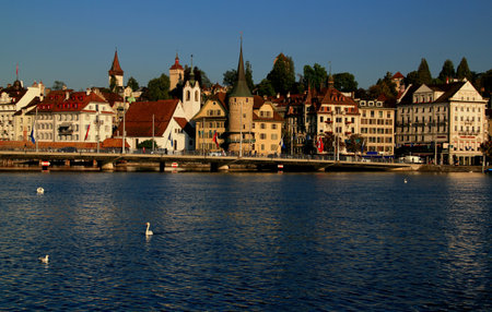 Lucerne, Switzerland-09.05.2018: Photo with the view of Lake Lucerne waterfront with historic buildings and swans in the foregroundのeditorial素材