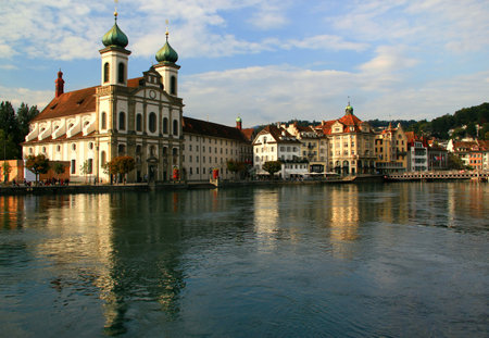 Lucerne, Switzerland-06/09/2018: Photo with the view of Lake Lucerne waterfront with historic buildings, iron bridge and Jesuitenkircheのeditorial素材