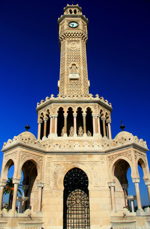Photo with the view from below of the Konak Clock Tower againt the clear blue sky in the historic center of Izmir, Turkeyの写真素材