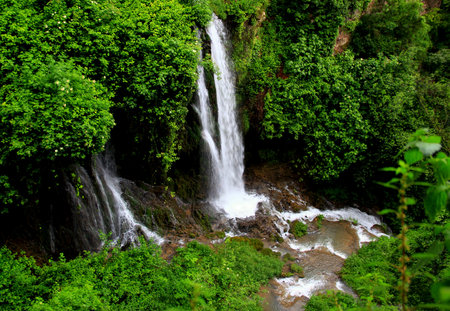 Tivoli, Italy -May 31, 2019: Photo of a landscape with a waterfall and green trees and bushes in the park of the Villa Gregoriana in Tivoliのeditorial素材