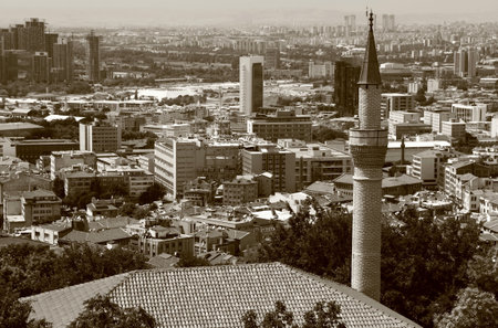 Panoramic view of the city of Ankara (Turkey) with the minaret of the mosque in the foreground with sepia effectの写真素材
