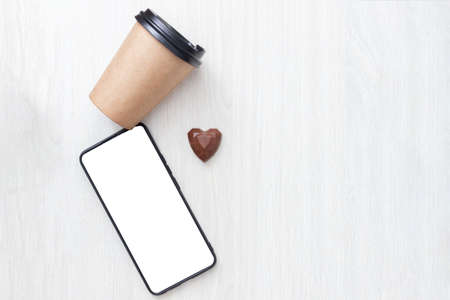 mock up smartphone, heart, craft cup on a gray wooden background