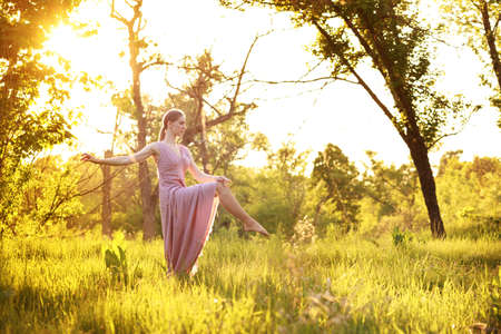 attractive girl ballerina dancing in natureの写真素材