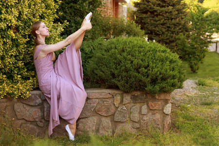 female dancer stretch in a botanical garden. postcard. bannerの写真素材