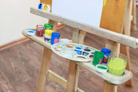 paints of the artist on an easel in a classの写真素材