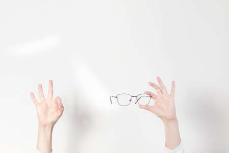 ok sign and glasses for vision on a white background. copyspaceの写真素材