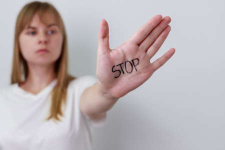 Close up view of young woman making stop gesture with her hand.の写真素材
