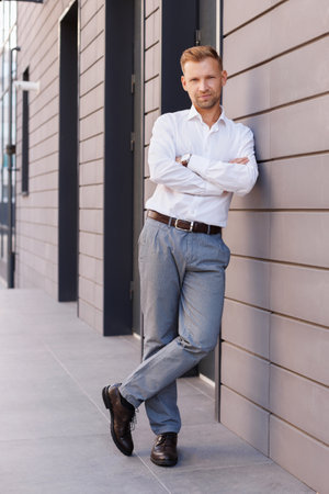 portrait of a handsome man in a white shirt near the business center.の写真素材
