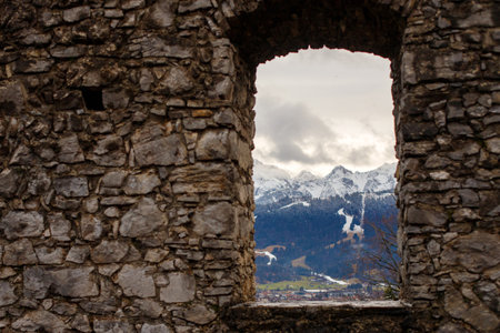 Window opening in an old building with a mountain viewの写真素材
