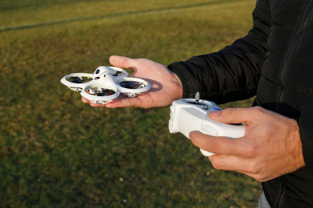 Close-up of a Man Operating a Drone with Remote Control
