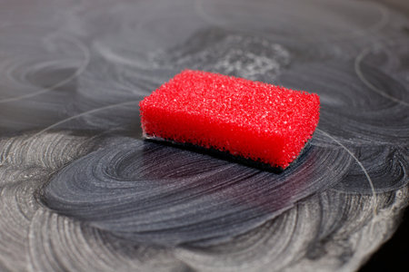 Cleaning agent for ceramic electric hobs. removing grease and dirt from an electric stove. sponge for cleaning in the kitchenの写真素材