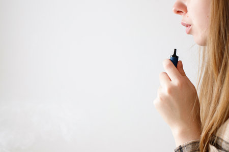 close up woman smoking vape