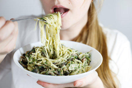 woman eating pasta close-upの写真素材