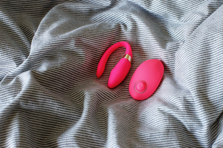 pink sex vibrator in bed. sex toysの写真素材