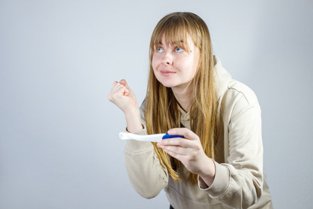 woman looking at a pregnancy testの写真素材