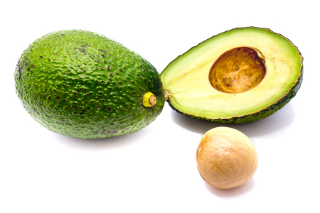 Avocado (Persea americana, alligator pear) slices and one whole avocado with a stone isolated on white background
の写真素材