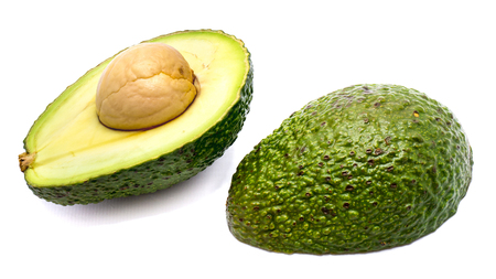 Avocado halves (Persea americana, alligator pear) with a stone isolated on white background
の写真素材