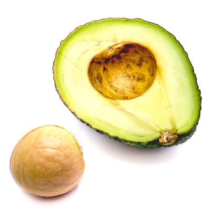 Sliced avocado (Persea americana, alligator pear) with a stone isolated on white background
の写真素材