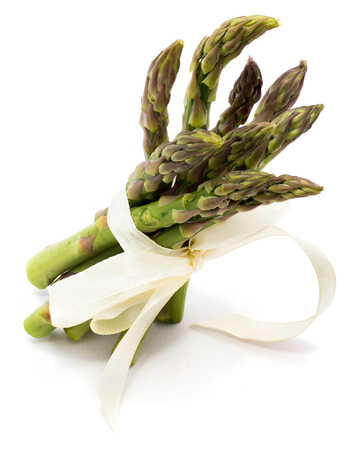 Bunch of raw asparagus tied with a creamy knot isolated on white background
の写真素材