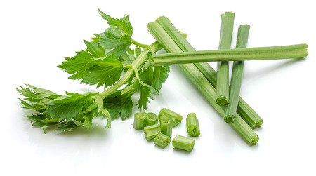 Sliced fresh celery pieces, sticks and leaves, isolated on white background
の写真素材