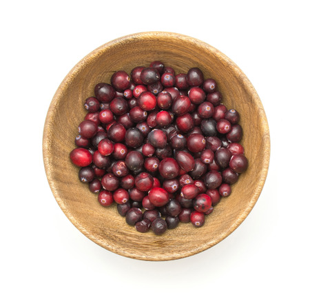 Cranberries in a wooden bowl isolated on white background top view
の写真素材