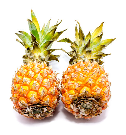 Two whole pineapples isolated on white background