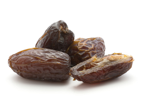 Date fruit Medjool variety three whole and one half isolated on white background
の写真素材