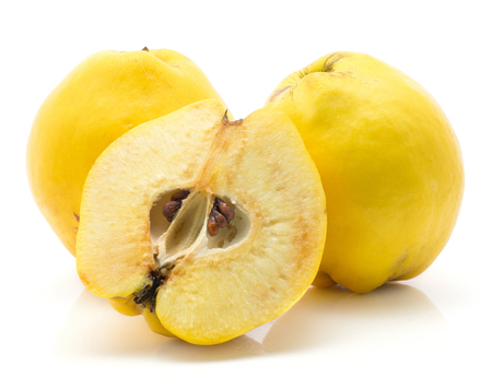 Yellow quinces two whole and one half isolated on white background raw ripeの写真素材