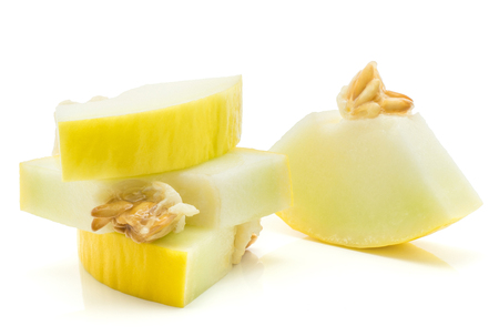 Yellow honeydew melon four cut pieces with seeds isolated on white background
の写真素材