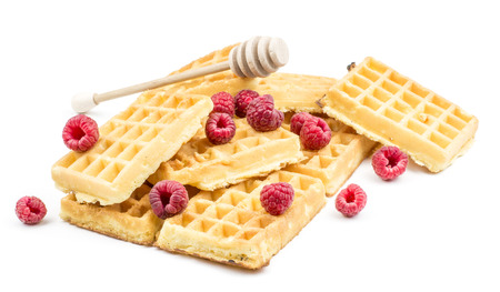 Traditional waffle (Belgian) stack with fresh red raspberries and honey isolated on white background sweet delicate and airy
の写真素材