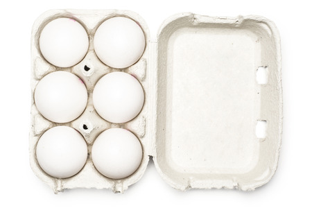 Six white chicken eggs in a paper grey crate isolated on white background top view
の写真素材