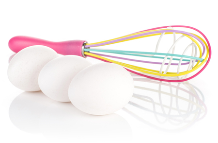 Three white chicken eggs and silicon colourful balloon whisk isolated on white background
の写真素材