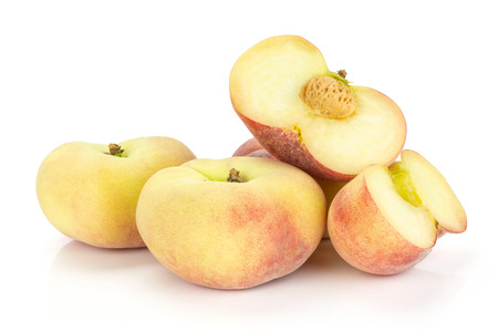 Fresh ripe Saturn peaches stack and two sliced halves isolated on white backgroundの写真素材